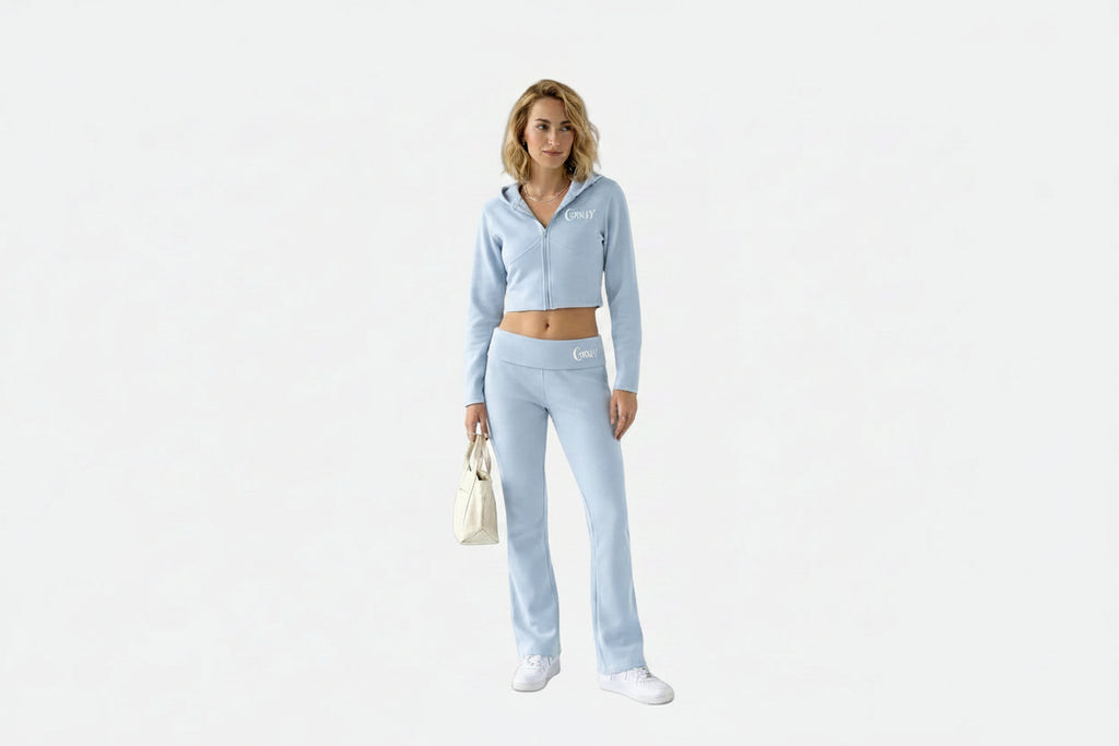 Woman wearing a light blue tracksuit on a white background