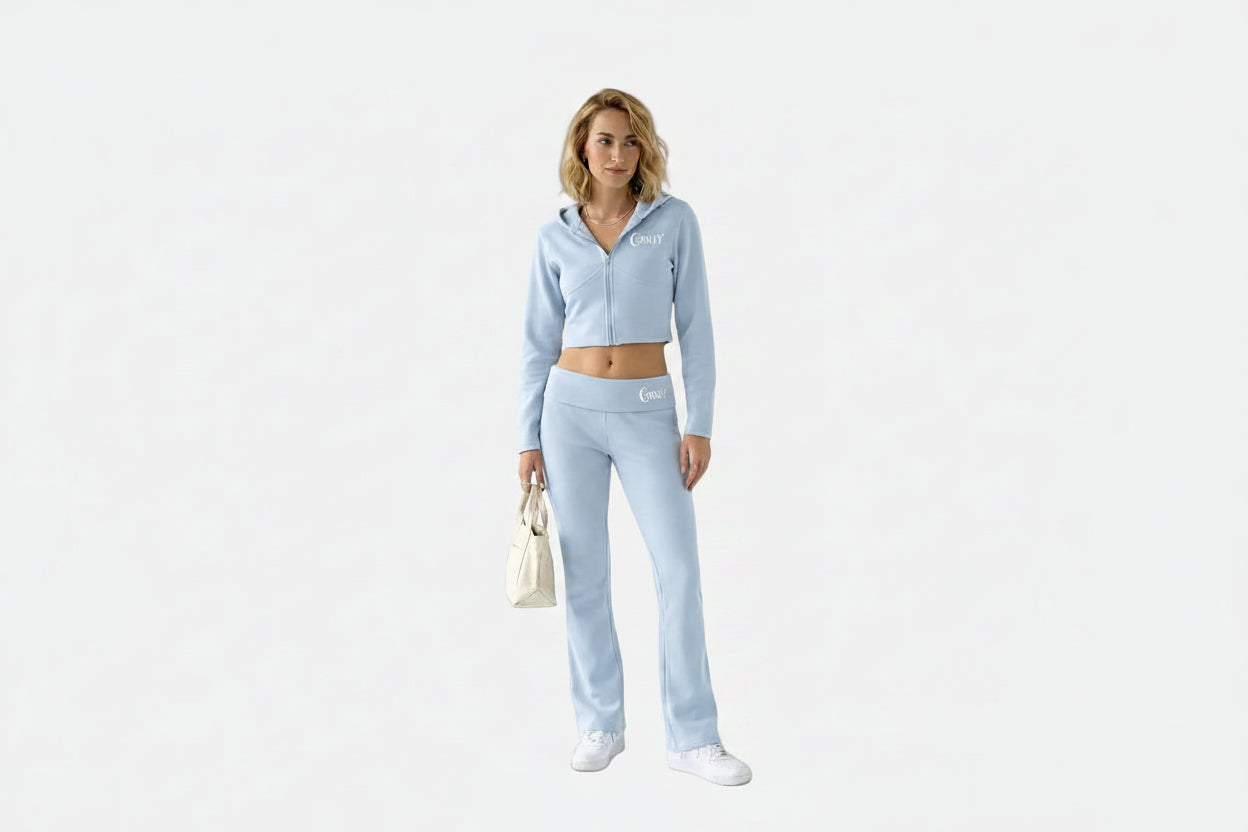 Woman wearing a light blue tracksuit on a white background